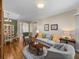Open floorplan living room with hardwood floors connects to dining area at 34714 Heavenly Ln, Dade City, FL 33525