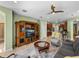 Cozy living room features a large entertainment center and seamless access to the kitchen at 34714 Heavenly Ln, Dade City, FL 33525