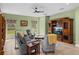 Living area features comfortable seating, a ceiling fan, natural light, and an entertainment center at 34714 Heavenly Ln, Dade City, FL 33525