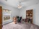 Office area with a desk, chair, book shelves, and large window at 34714 Heavenly Ln, Dade City, FL 33525