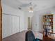 Well-lit office features a closet, desk, chair, and built-in bookshelf at 34714 Heavenly Ln, Dade City, FL 33525