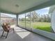 Enclosed screened patio with large sliding windows and a comfortable chair at 34714 Heavenly Ln, Dade City, FL 33525