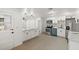 Spacious open-concept kitchen featuring a large island, white cabinets, and modern lighting at 36343 Ionno Ct, Zephyrhills, FL 33541