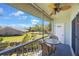 View of a screened-in balcony with seating, overlooking green space at 387 S Mcmullen Booth Rd # 16, Clearwater, FL 33759