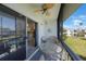 View of a screened-in balcony with seating and a glass-top table at 387 S Mcmullen Booth Rd # 16, Clearwater, FL 33759