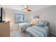 This bedroom is furnished with twin beds and a ceiling fan at 387 S Mcmullen Booth Rd # 16, Clearwater, FL 33759