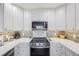 Bright kitchen with stainless steel appliances, white cabinetry, and modern countertops, well-lit space at 387 S Mcmullen Booth Rd # 16, Clearwater, FL 33759