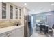 Updated kitchen featuring stainless steel appliances, white cabinetry, and a dining area near the window at 387 S Mcmullen Booth Rd # 16, Clearwater, FL 33759