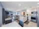 Bright open-concept living space with a modern kitchen, cozy living room furniture, and updated flooring at 387 S Mcmullen Booth Rd # 16, Clearwater, FL 33759