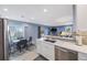 Open-concept layout with the kitchen leading to a living space with a dining area and sliding door access at 387 S Mcmullen Booth Rd # 16, Clearwater, FL 33759