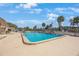 A luxurious pool with chairs, lounges, and tiki umbrellas at 387 S Mcmullen Booth Rd # 16, Clearwater, FL 33759
