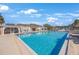 A luxurious pool surrounded by chairs, lounges, and tiki umbrellas at 387 S Mcmullen Booth Rd # 16, Clearwater, FL 33759
