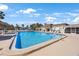 Community pool and tiki hut with plenty of lounge chairs and a beautiful clubhouse in the background at 387 S Mcmullen Booth Rd # 16, Clearwater, FL 33759