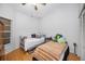Bright bedroom with hardwood floors, two twin beds, and a window for natural light at 39650 Us Highway 19 N # 1422, Tarpon Springs, FL 34689