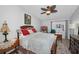 Bedroom with a ceiling fan, a window view of the neighborhood, and an ornate wood bed frame at 39650 Us Highway 19 N # 1422, Tarpon Springs, FL 34689