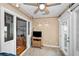 Bonus room featuring a tv and rattan stand, tile floors, and glass doors to backyard at 39650 Us Highway 19 N # 1422, Tarpon Springs, FL 34689