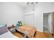 Bright bedroom with hardwood floors, closet with folding doors and a view into the ensuite bathroom at 39650 Us Highway 19 N # 1422, Tarpon Springs, FL 34689