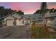Charming exterior of a townhouse with an American flag and attached garage, complemented by vibrant landscaping and a palm tree at 39650 Us Highway 19 N # 1422, Tarpon Springs, FL 34689