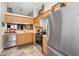Bright kitchen with stainless appliances, wood cabinets, and tile backsplash at 39650 Us Highway 19 N # 1422, Tarpon Springs, FL 34689