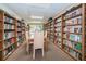 Community library with floor to ceiling bookshelves and tables for reading at 39650 Us Highway 19 N # 1422, Tarpon Springs, FL 34689