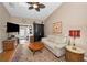 Cozy living room featuring a ceiling fan, hardwood floors, and comfortable furnishings at 39650 Us Highway 19 N # 1422, Tarpon Springs, FL 34689