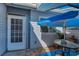 Cozy outdoor patio area with a blue umbrella and table at 39650 Us Highway 19 N # 1422, Tarpon Springs, FL 34689