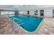 Indoor pool featuring pool ladder and tiled deck for relaxing at 39650 Us Highway 19 N # 1422, Tarpon Springs, FL 34689