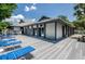Exterior view of the pool house, deck, and lounge chairs at 39650 Us Highway 19 N # 1422, Tarpon Springs, FL 34689