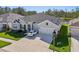 Beautiful home featuring manicured landscaping, a three-car garage, and a well-maintained lawn at 4032 Tour Trce, Land O Lakes, FL 34638