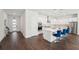 A kitchen with an island and counter seating is open to the foyer with front door at 4032 Tour Trce, Land O Lakes, FL 34638