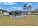 View of a spacious backyard with a screened pool and entertainment area, offering a relaxing outdoor living space at 4118 Ramona Dr, Spring Hill, FL 34606