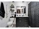 Bathroom featuring modern black vanity, patterned tile floor, and a shower with a stylish curtain at 4118 Ramona Dr, Spring Hill, FL 34606