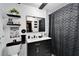 Bathroom featuring modern black vanity, patterned tile floor, and a shower with a stylish curtain at 4118 Ramona Dr, Spring Hill, FL 34606