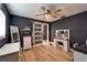 Bedroom showcasing warm wood floors, vanity, and a frosted sliding door to closet at 4118 Ramona Dr, Spring Hill, FL 34606