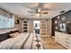 This is a calm bedroom with a decorative wall, light floors, and barn door leading to the bathroom at 4118 Ramona Dr, Spring Hill, FL 34606