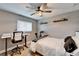 Small bedroom area with neutral color walls, desk, bed, light floors, and good natural light at 4118 Ramona Dr, Spring Hill, FL 34606