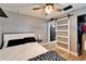 Stylish bedroom with a modern ceiling fan, sleek sliding door, and light wood flooring at 4118 Ramona Dr, Spring Hill, FL 34606