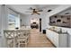 Bright dining area featuring a modern ceiling fan and a view of the kitchen through a serving hatch at 4118 Ramona Dr, Spring Hill, FL 34606