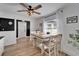 Cozy dining area with wooden floors, ceiling fan, and view to the black accent wall at 4118 Ramona Dr, Spring Hill, FL 34606