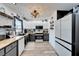 Well-lit kitchen with white subway tile backsplash, butcher block counters, and a modern light fixture at 4118 Ramona Dr, Spring Hill, FL 34606