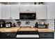 Butcher block countertop next to the black oven and white cabinets with black hardware at 4118 Ramona Dr, Spring Hill, FL 34606