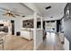 Open-concept living room with hardwood floors, stylish decor, and seamless transition to the outdoors pool at 4118 Ramona Dr, Spring Hill, FL 34606