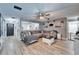 Spacious living room with hardwood floors, modern furniture, and plenty of natural light at 4118 Ramona Dr, Spring Hill, FL 34606