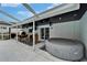 Outdoor patio with a hot tub, seating area, and covered structure, perfect for entertaining and relaxing at 4118 Ramona Dr, Spring Hill, FL 34606