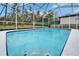 Sparkling pool with screened enclosure and manicured landscaping creating a private oasis for relaxation at 4118 Ramona Dr, Spring Hill, FL 34606