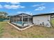 Enclosed pool featuring a well-maintained yard with decorative rock border, perfect for leisure and privacy at 4118 Ramona Dr, Spring Hill, FL 34606
