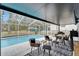Covered patio seating area next to screened-in pool at 4118 Ramona Dr, Spring Hill, FL 34606