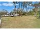 Expansive backyard featuring mature trees, providing shade and a serene natural setting at 4118 Ramona Dr, Spring Hill, FL 34606