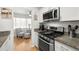 Modern kitchen features stainless steel appliances and white cabinetry at 5227 81St N Ln # 15, St Petersburg, FL 33709