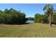 Beautiful, grassy backyard with palm tree and path leading to the waterway at 5400 Park N St # 200, St Petersburg, FL 33709
